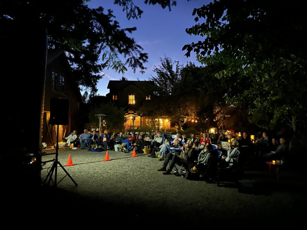 A group of people enjoying an outdoor screening produced by AVFilm's Cinema Concierge